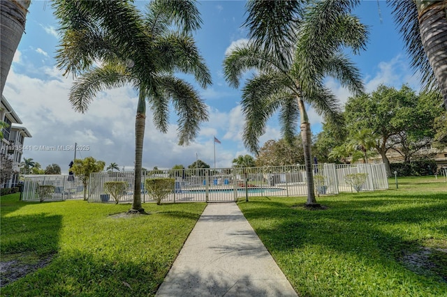surrounding community with a lawn and a pool