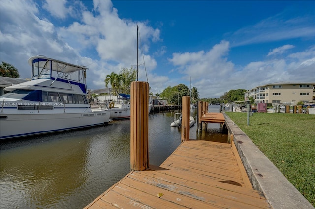 dock area featuring a water view and a lawn