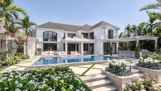 rear view of property featuring a patio area, exterior bar, a pergola, and a balcony