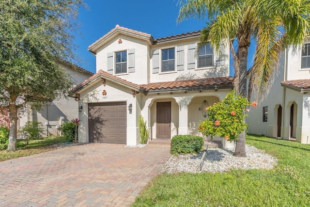 mediterranean / spanish-style house featuring a front yard