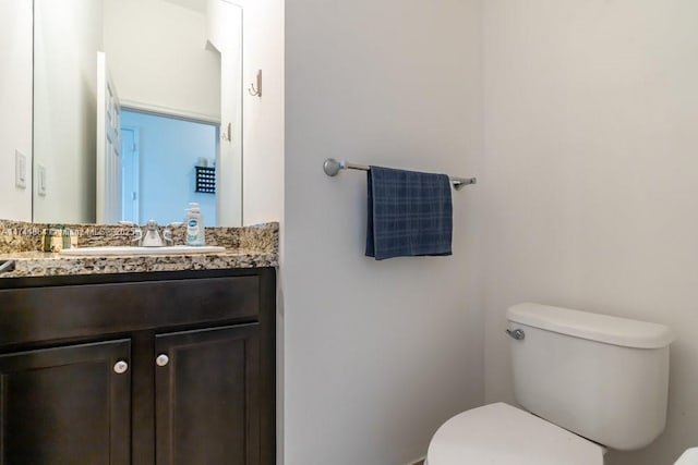 bathroom featuring toilet and vanity