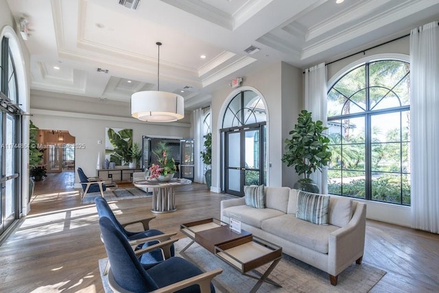 interior space featuring a high ceiling, wood-type flooring, coffered ceiling, beamed ceiling, and ornamental molding