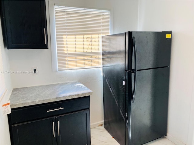 kitchen featuring black fridge