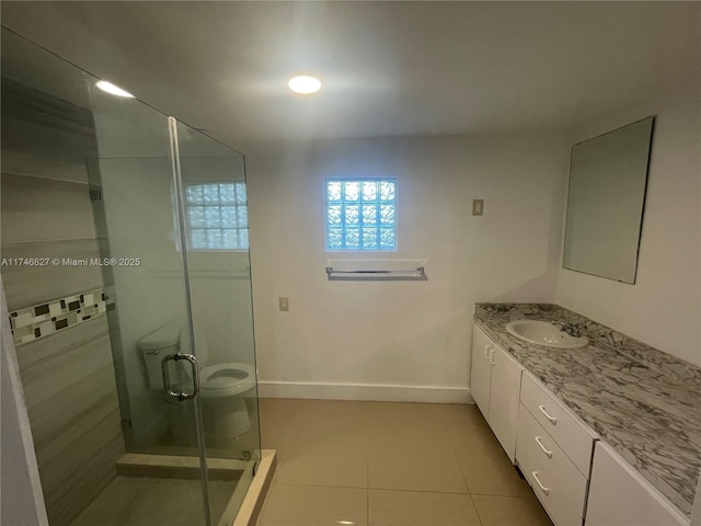 bathroom featuring vanity, toilet, tile patterned floors, and walk in shower