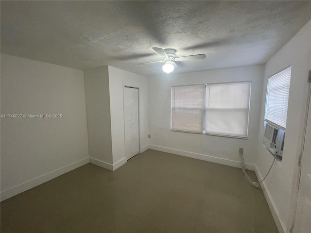 unfurnished bedroom with ceiling fan, cooling unit, a textured ceiling, and a closet