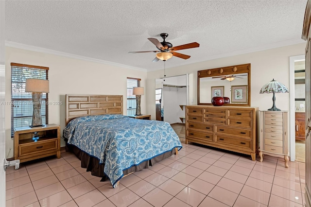 bedroom with light tile patterned floors, ornamental molding, and a textured ceiling