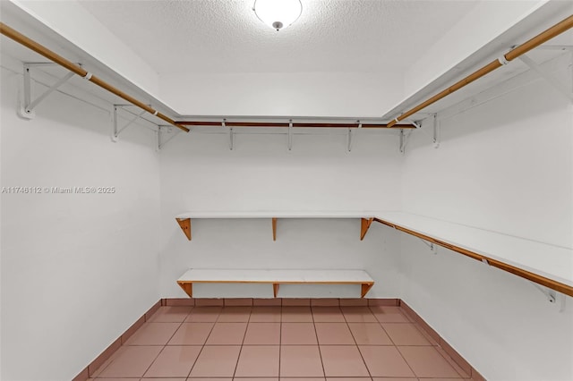 walk in closet featuring light tile patterned flooring