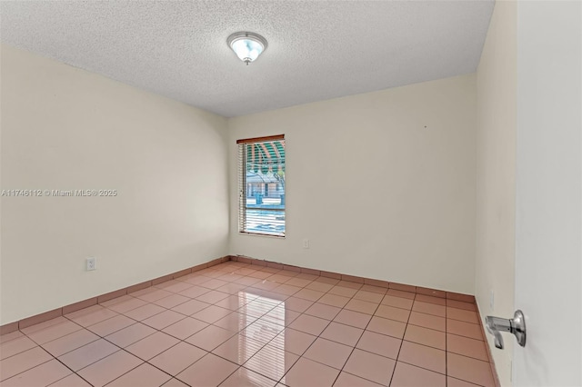 unfurnished room featuring light tile patterned floors and a textured ceiling