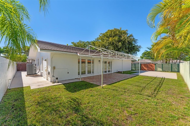back of house with a patio, french doors, a fenced backyard, and central air condition unit