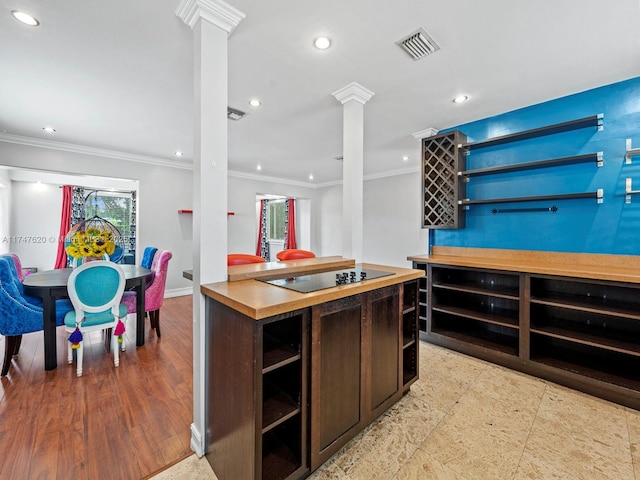 kitchen with ornamental molding, black electric cooktop, and decorative columns