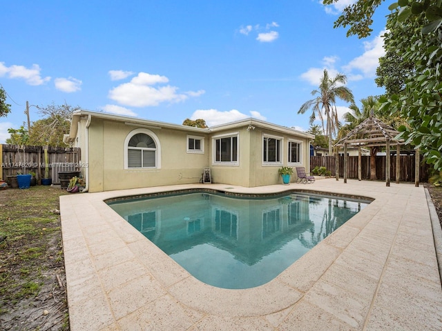 back of house featuring a patio area, a fenced in pool, and a gazebo