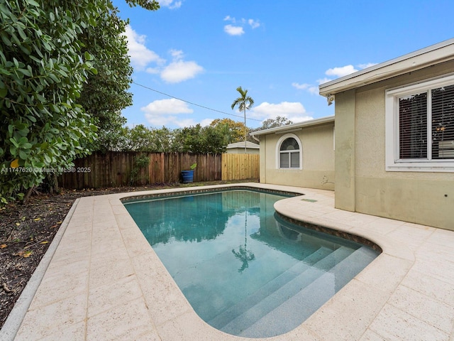 view of swimming pool featuring a patio area