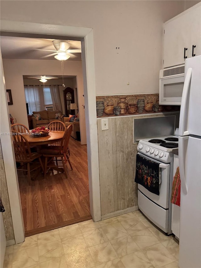 kitchen featuring ceiling fan, white appliances, and white cabinetry