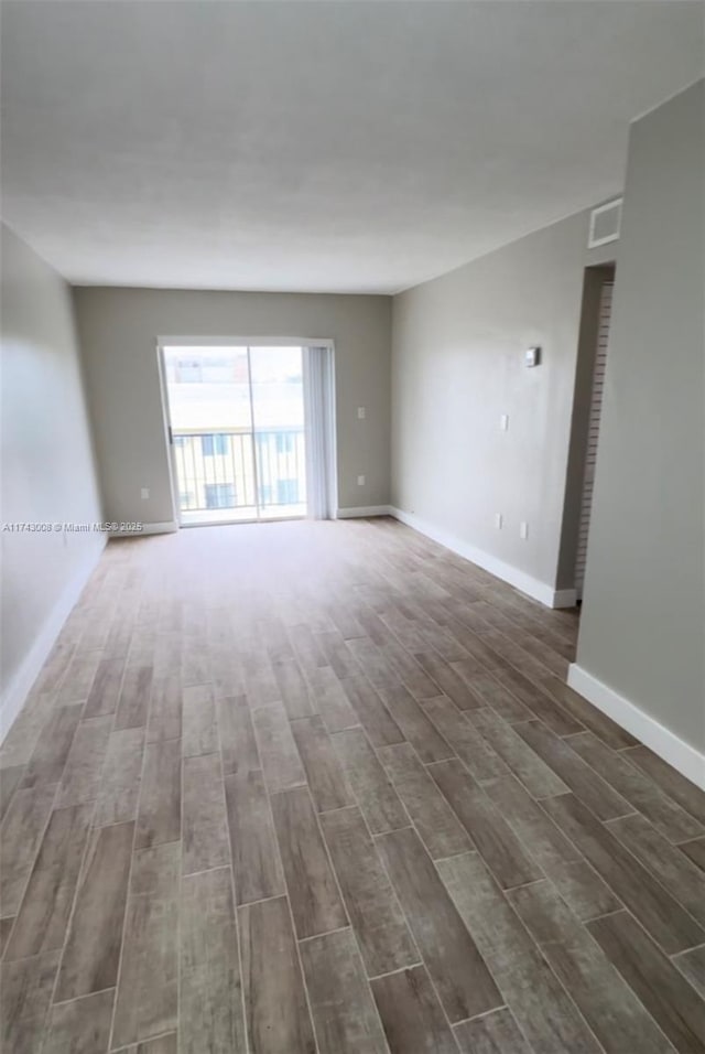 spare room featuring dark hardwood / wood-style flooring