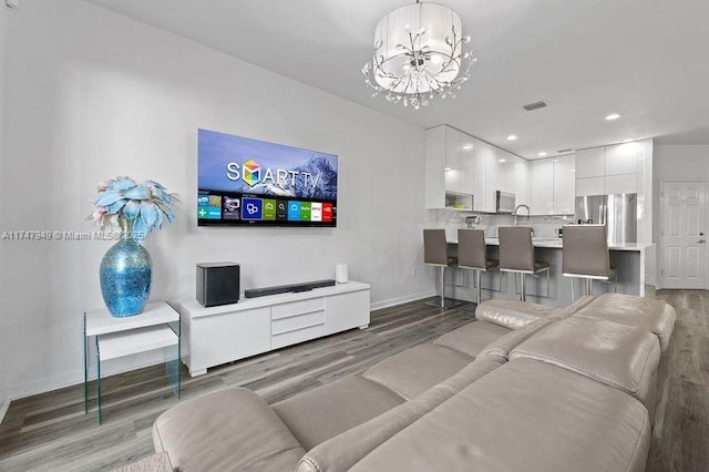 living room featuring a notable chandelier and hardwood / wood-style floors