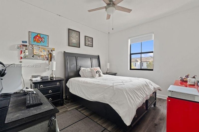 bedroom with dark wood-type flooring and ceiling fan