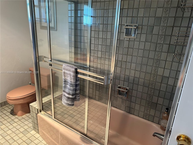 full bath featuring toilet, tile patterned flooring, and combined bath / shower with glass door