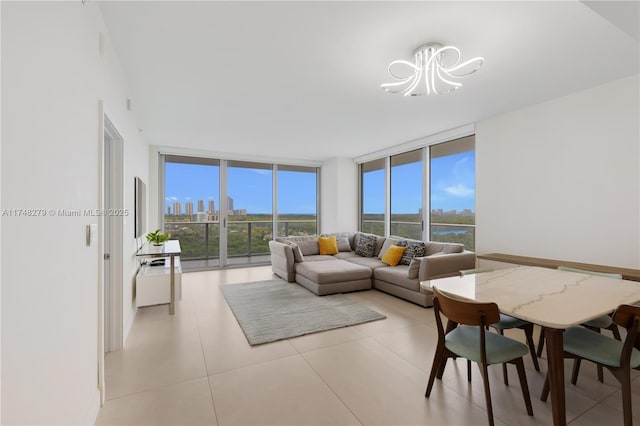 living area with a wealth of natural light, floor to ceiling windows, and a notable chandelier