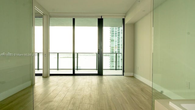 650 NE 32nd St Unit 2105, Miami, FL 33137 - empty room featuring wood finished floors and floor to ceiling windows