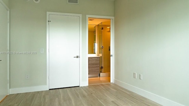 650 NE 32nd St Unit 2105, Miami, FL 33137 - unfurnished bedroom featuring wood finished floors and ensuite bath