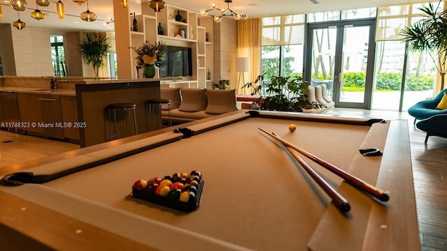650 NE 32nd St Unit 2105, Miami, FL 33137 - playroom featuring billiards table, a chandelier, and wood finished floors