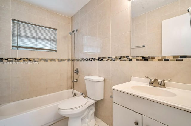 bathroom featuring toilet, vanity, bathtub / shower combination, and tile walls