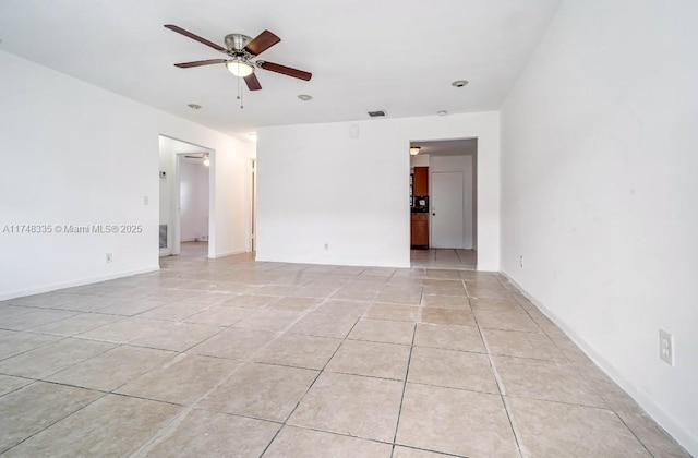 unfurnished room featuring ceiling fan, visible vents, and light tile patterned flooring