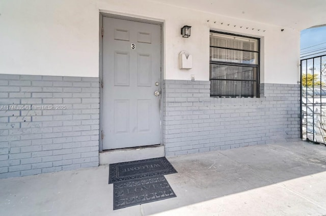 property entrance with brick siding