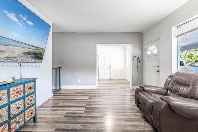 living area featuring wood finished floors and baseboards