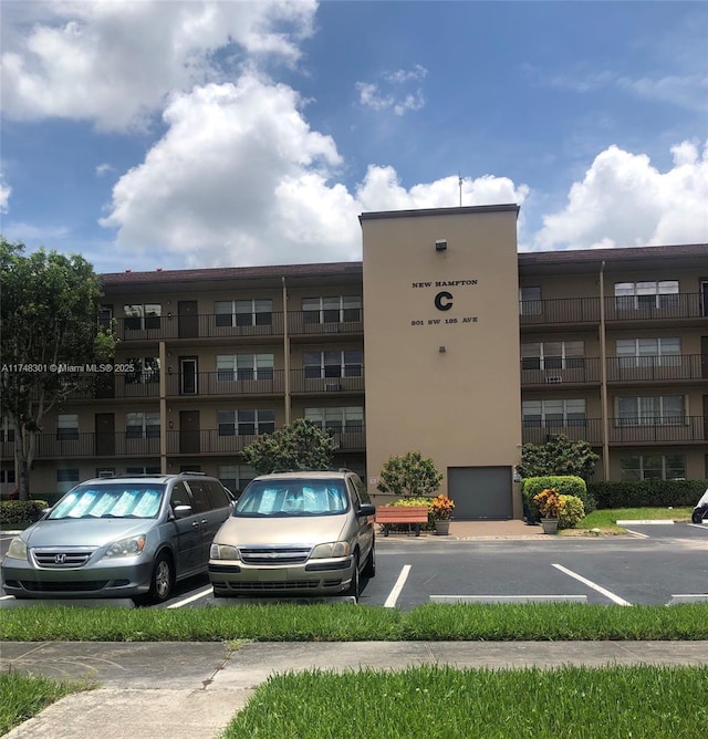 view of building exterior featuring uncovered parking