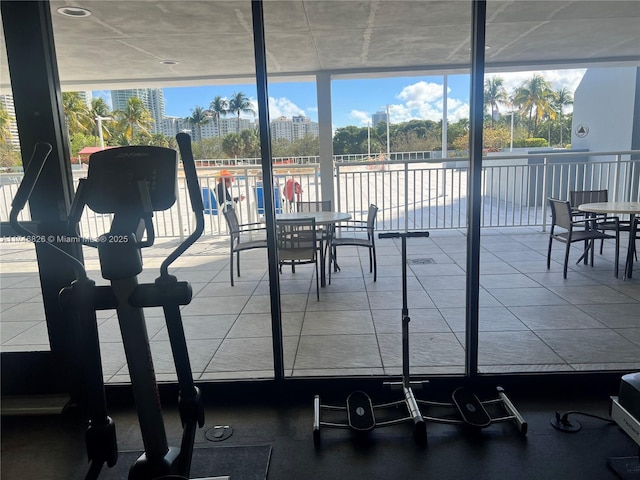 gym with a wall of windows and a healthy amount of sunlight