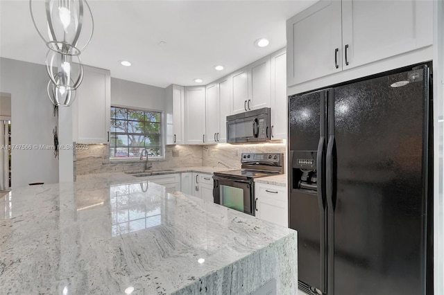 kitchen featuring white cabinetry, pendant lighting, sink, and black appliances