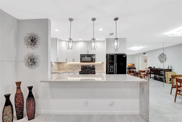 kitchen featuring white cabinetry, kitchen peninsula, decorative light fixtures, black appliances, and light stone countertops