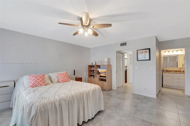 bedroom with ceiling fan, sink, and ensuite bath