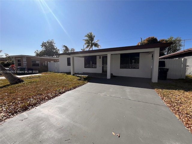 view of front facade with a front yard and a carport