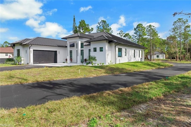 view of front of home with a garage and a front yard