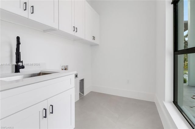 laundry area featuring cabinets, sink, electric dryer hookup, and hookup for a washing machine