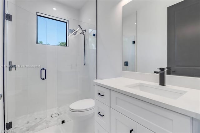 bathroom with toilet, vanity, and walk in shower