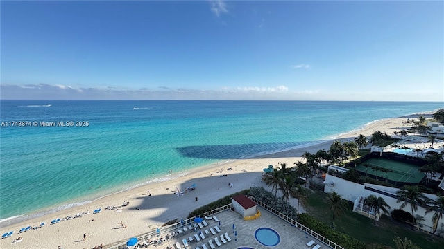 drone / aerial view with a beach view and a water view