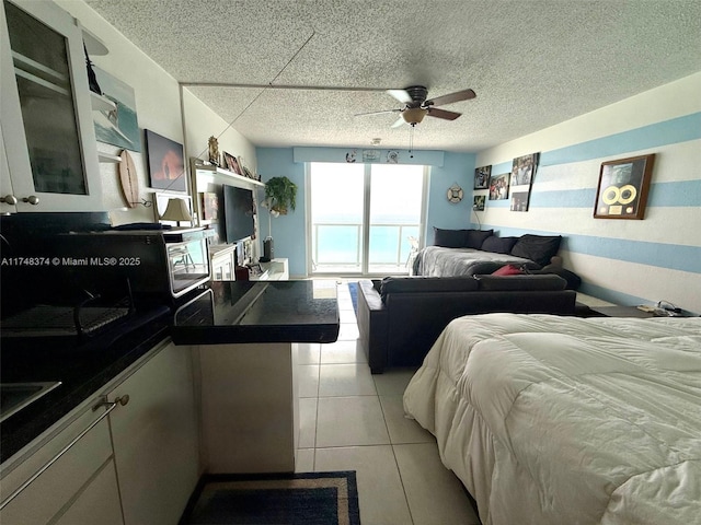 bedroom with a textured ceiling and light tile patterned flooring