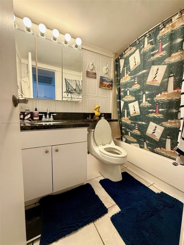 full bathroom with tile patterned floors, vanity, toilet, and shower / bath combination with curtain