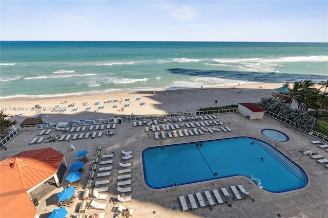 drone / aerial view with a water view and a view of the beach