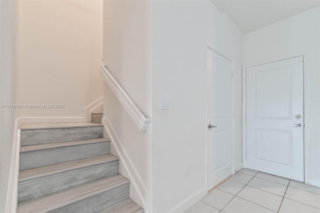 stairs with tile patterned flooring