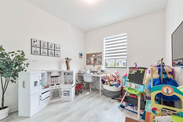 recreation room with light wood-style floors