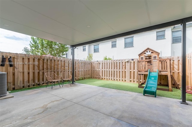 view of patio / terrace featuring a playground and a fenced backyard