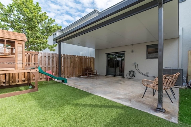 view of patio / terrace with a playground, fence, and cooling unit