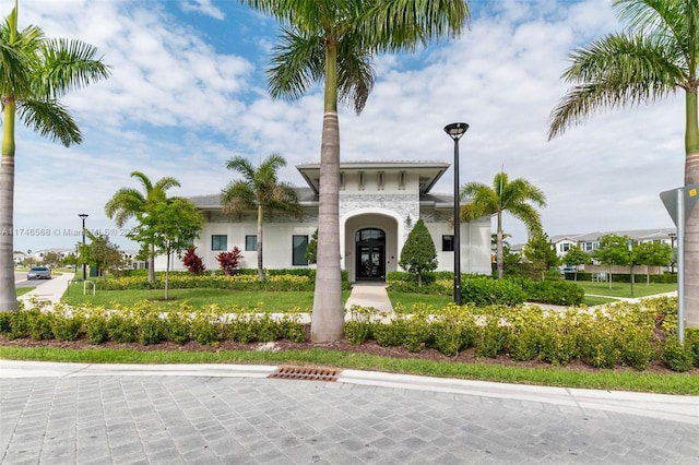 exterior space featuring a front lawn and stucco siding