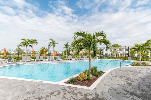 community pool featuring fence and a patio