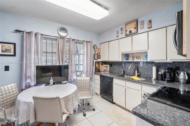 kitchen featuring black dishwasher, dark countertops, a sink, and white cabinets