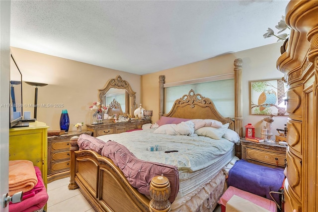 bedroom with a textured ceiling and light tile patterned flooring